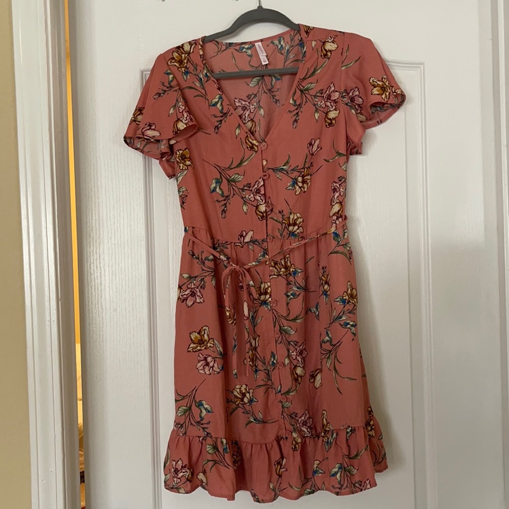 Pink dress with floral pattern. Mid thigh length, button down with waist tie